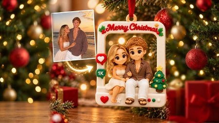 Personalized Christmas ornament with a 3D printed couple figurine sculpted from their beach photo, hanging by a red ribbon