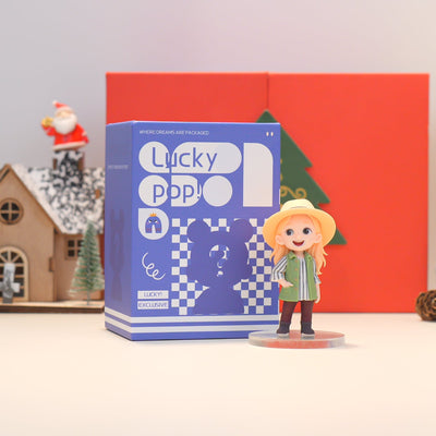 Figurine of a character in front of a 'Lucky Pop' box with a festive background