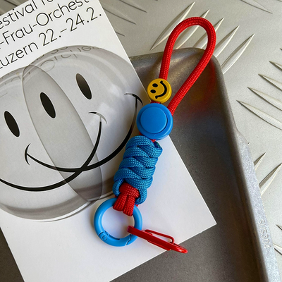 Colorful keychain with smiley face design on a white surface