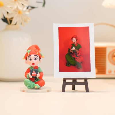 Colorful figurine of a character holding a camera next to a framed photo on a light surface.