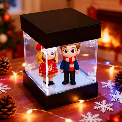Two animated characters in a decorative box with Christmas lights and decorations.