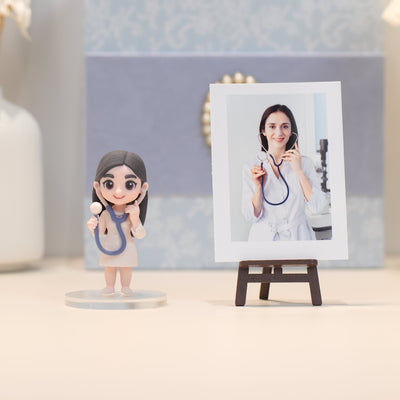 Figurine of a doctor with a stethoscope next to a photo of a real doctor on an easel.
