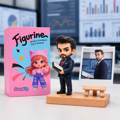 Figurine of a man in a suit next to its packaging and a photo stand with a photo on it, against a blurred office background.