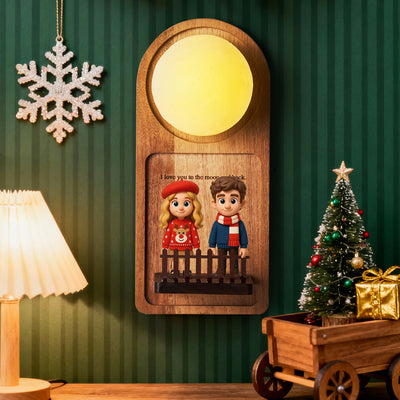 Decorative wall piece with cartoon characters, Christmas tree, and snowflake ornament on a green wall.