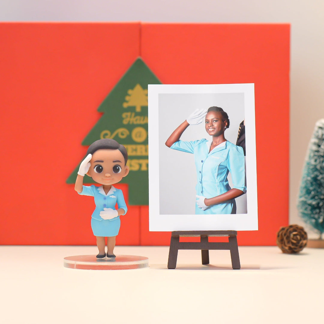 Figurine of a person in a blue uniform next to a photo on an easel against a red background with Christmas decorations.