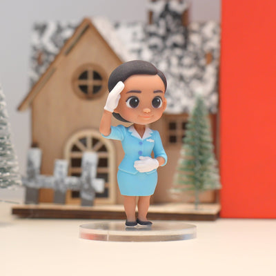 Toy figure of a person in a blue uniform with a blurred festive background