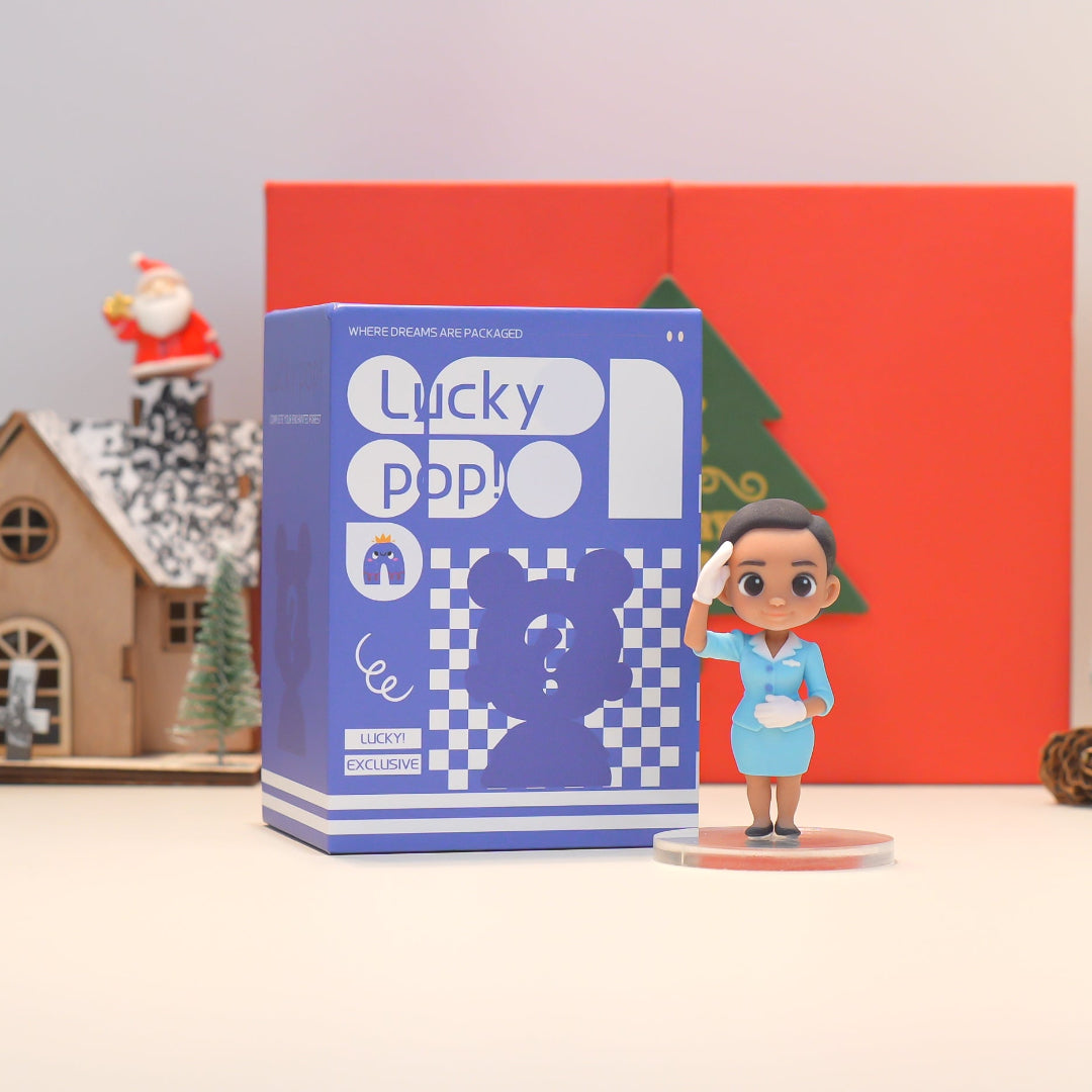 Figurine next to a 'Lucky Pop' box with Christmas decorations in the background