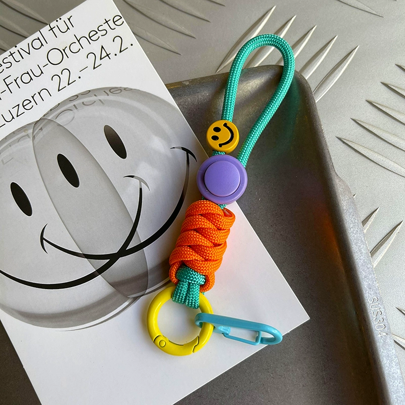 Colorful keychain with smiley face design on a white surface
