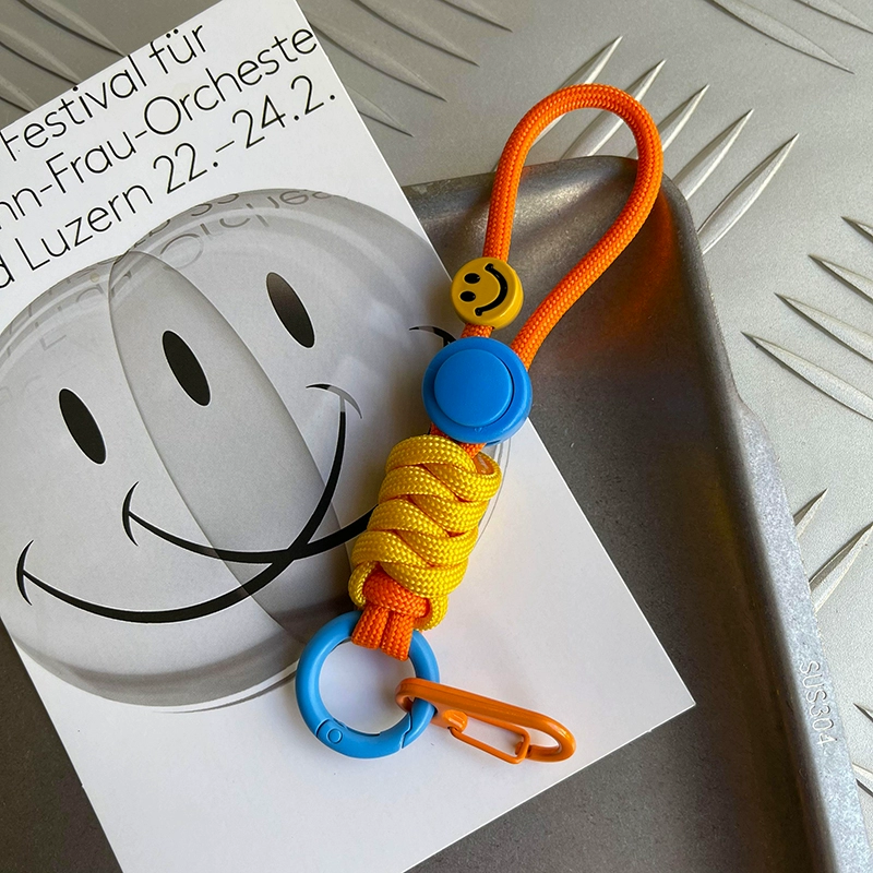 Colorful keychain with smiley face design on a white surface