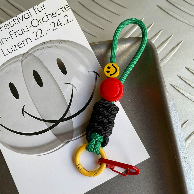 Colorful keychain with smiley face design on a white surface