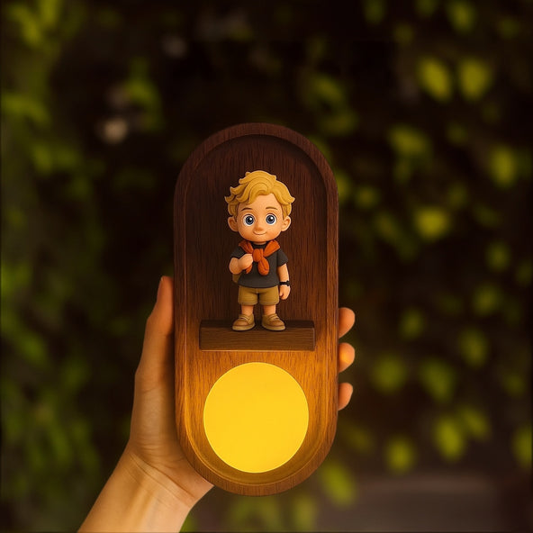 Wooden night light with a figurine of a boy holding a lamp, against a blurred green background.