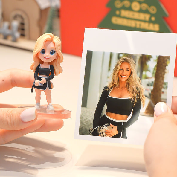 Person holding a figurine of a blonde woman and a photo of the same person outdoors.