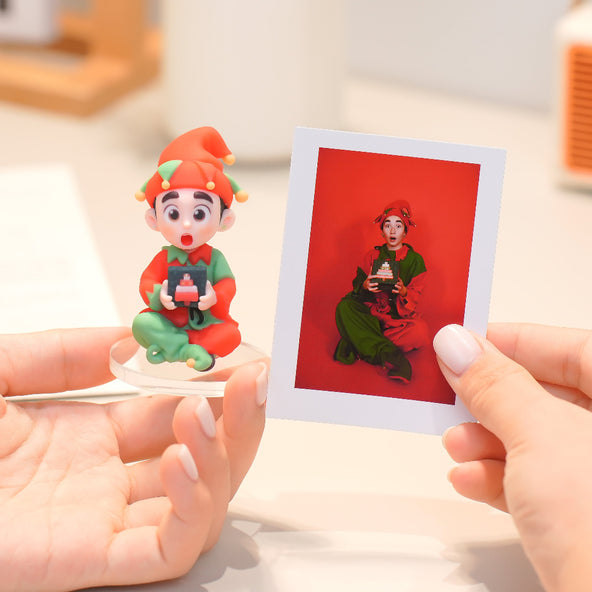Person holding a small figurine and a printed photo of a character with a red background.