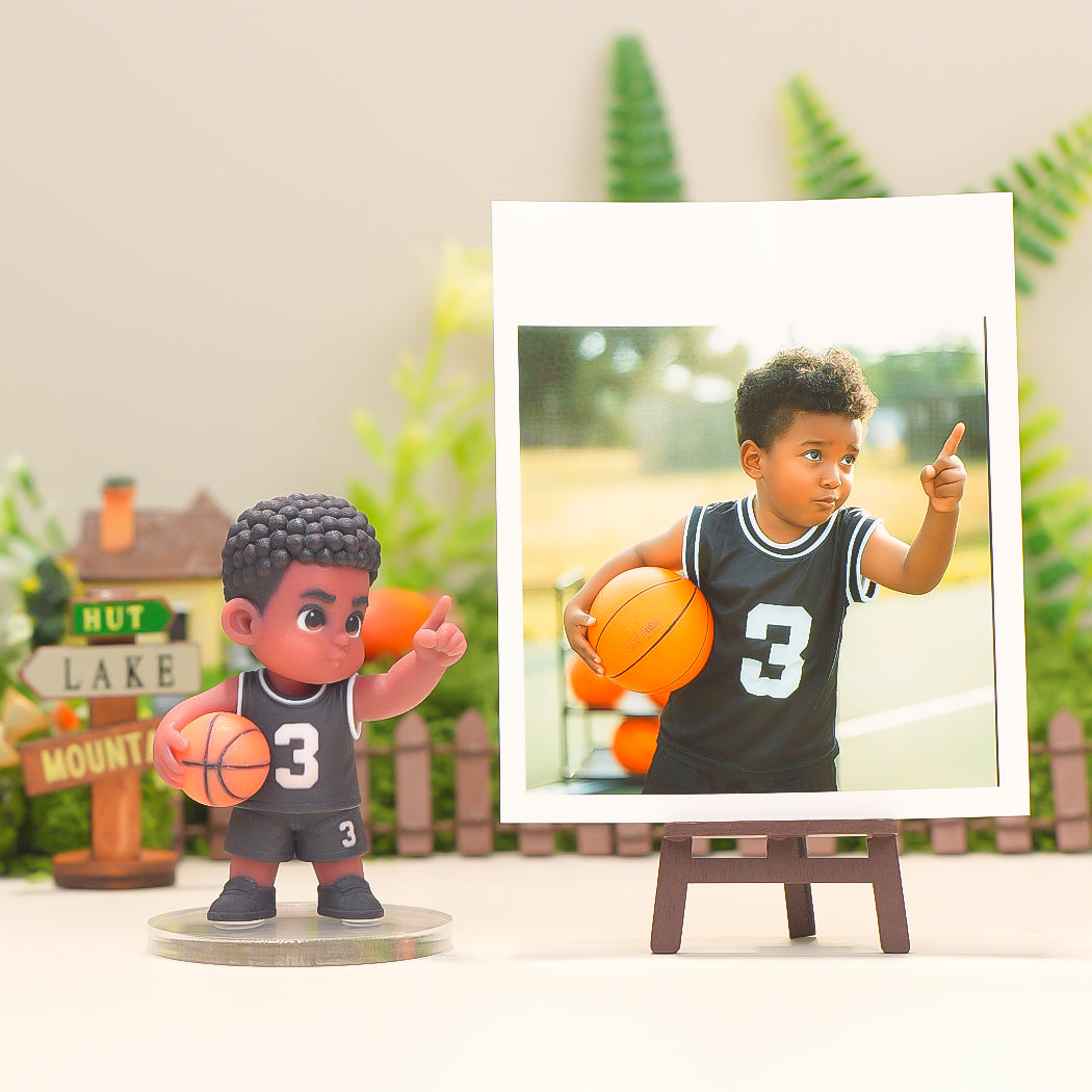 Figurine of a boy with basketball and photo of a boy holding a basketball on an easel.