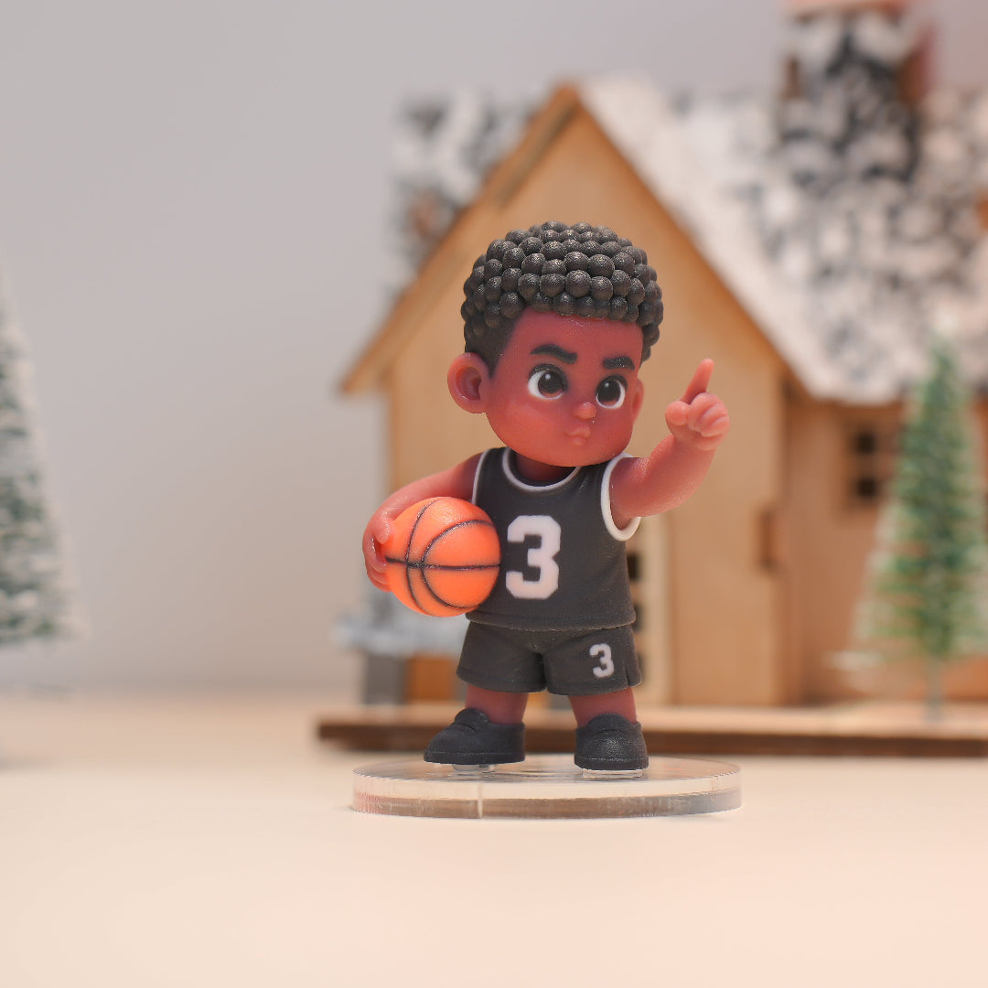 Figurine of a boy in a basketball jersey holding a ball, with a blurred background
