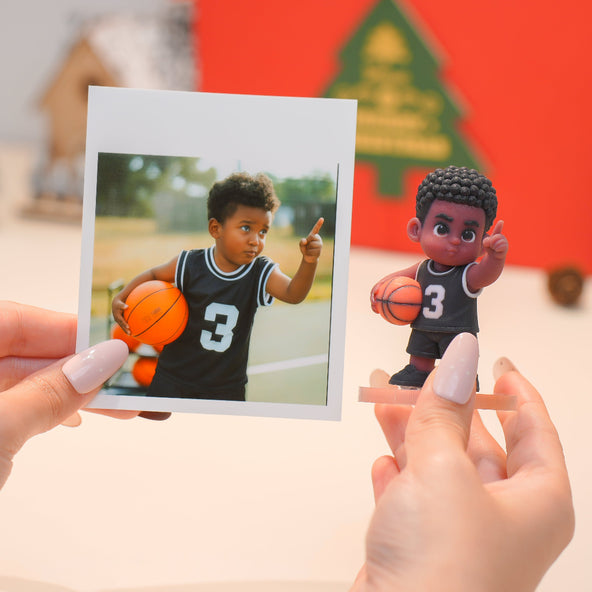 Person holding a photo of a child playing basketball next to a corresponding action figure.