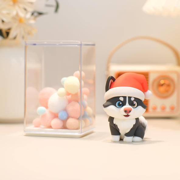 Small dog figurine wearing a Santa hat on a light background