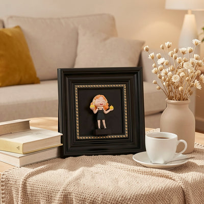 Open front wooden shadow box displaying a customized couple figurine standing on a home office desk