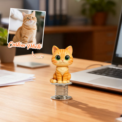 Cat-shaped desk organizer on a wooden desk with a laptop and photo frame in the background.