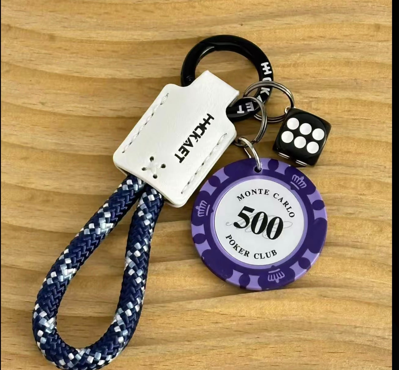 Keychain with poker chip design and dice on a wooden surface