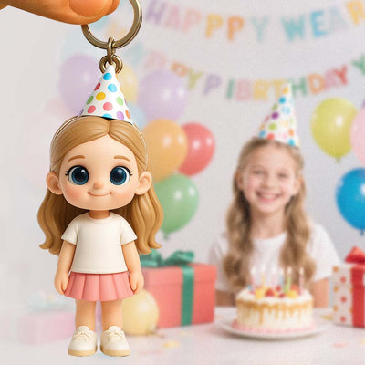 Keychain of a girl in a birthday hat with a blurred birthday scene in the background