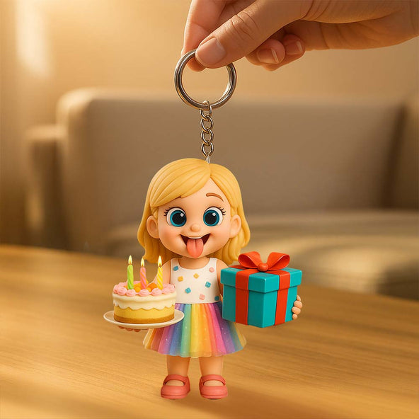 Keychain with a cartoon character holding a cake and gift box on a wooden surface.