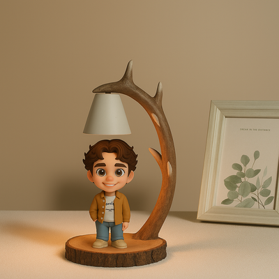 Figurine of a boy standing under a lamp with antler design on a wooden base, against a beige wall with a framed picture.